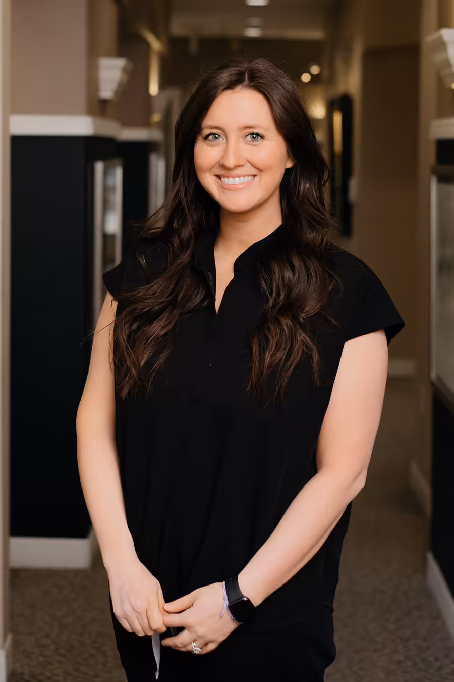 Kristen Portrait of Kristen, dental hygienist, standing in the office hallway.